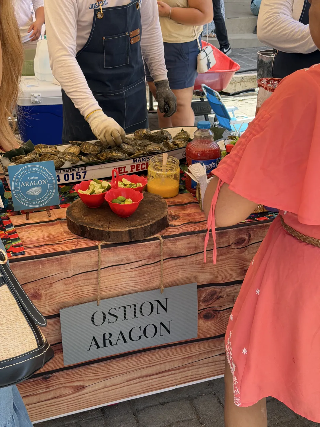 Fresh oysters served with lime and mango salsa at a Pescadero festival stand